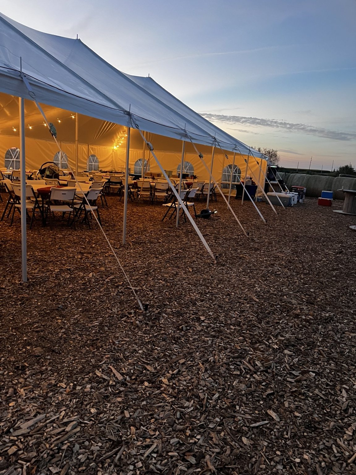 Lighted event tent setup at dusk