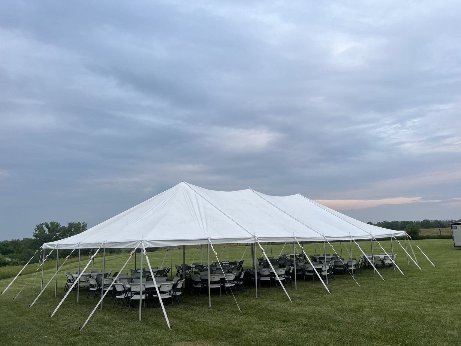 Large tent with round tables and chairs